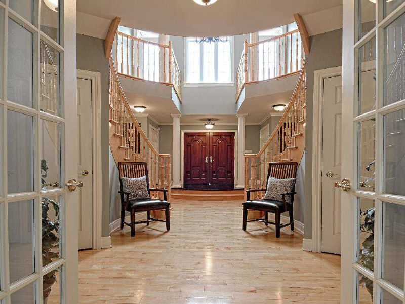 Double curved staircases flank the foyer.
